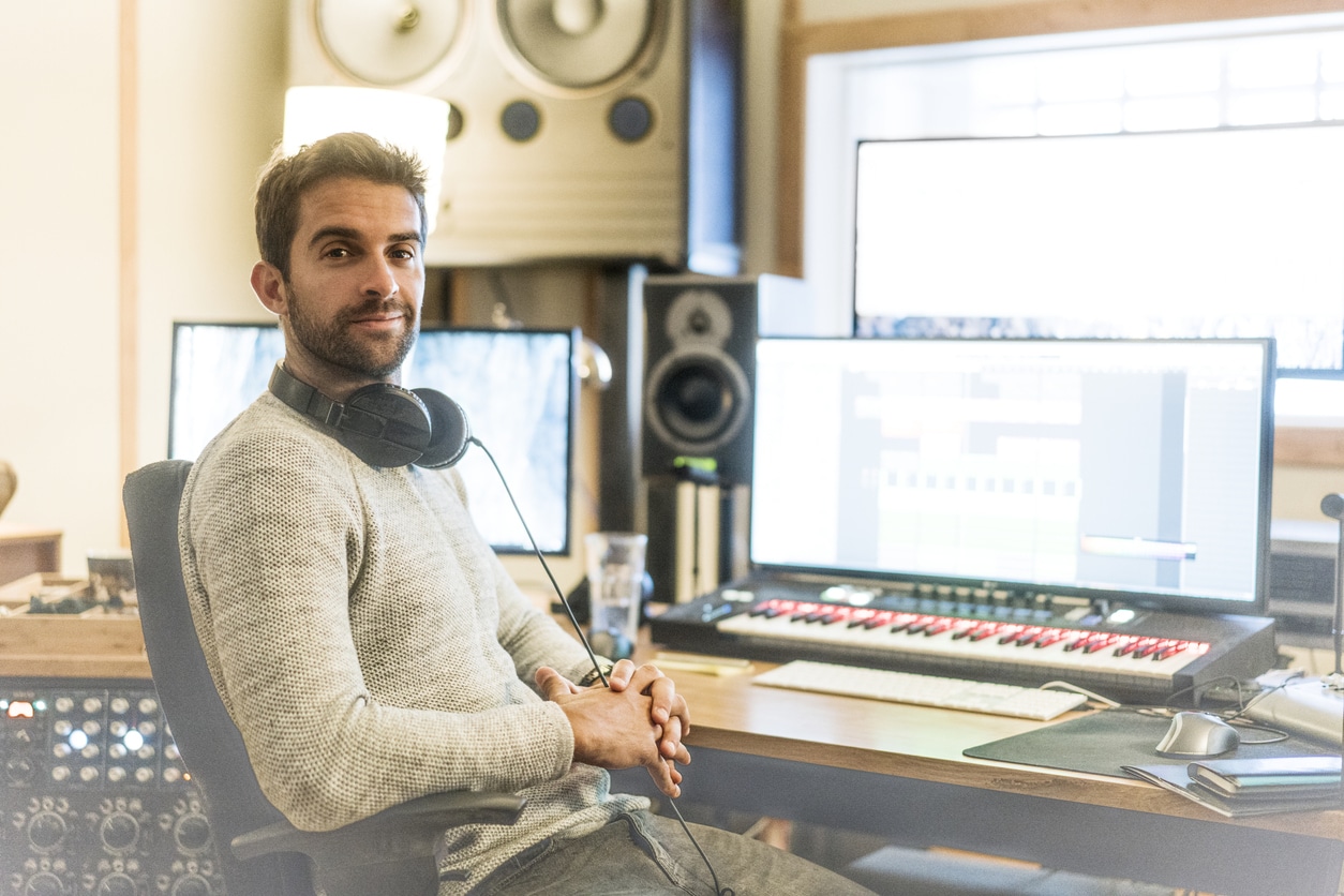 Man works on music with headphones