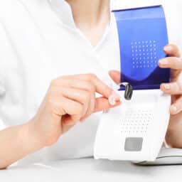 Audiologist showing a hearing aid dryer.