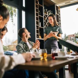 Group of people ordering food from the server.
